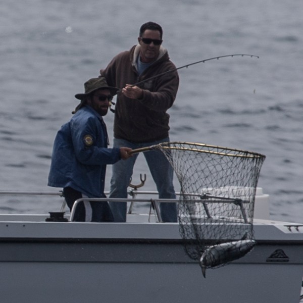 a man sitting on a boat in the water